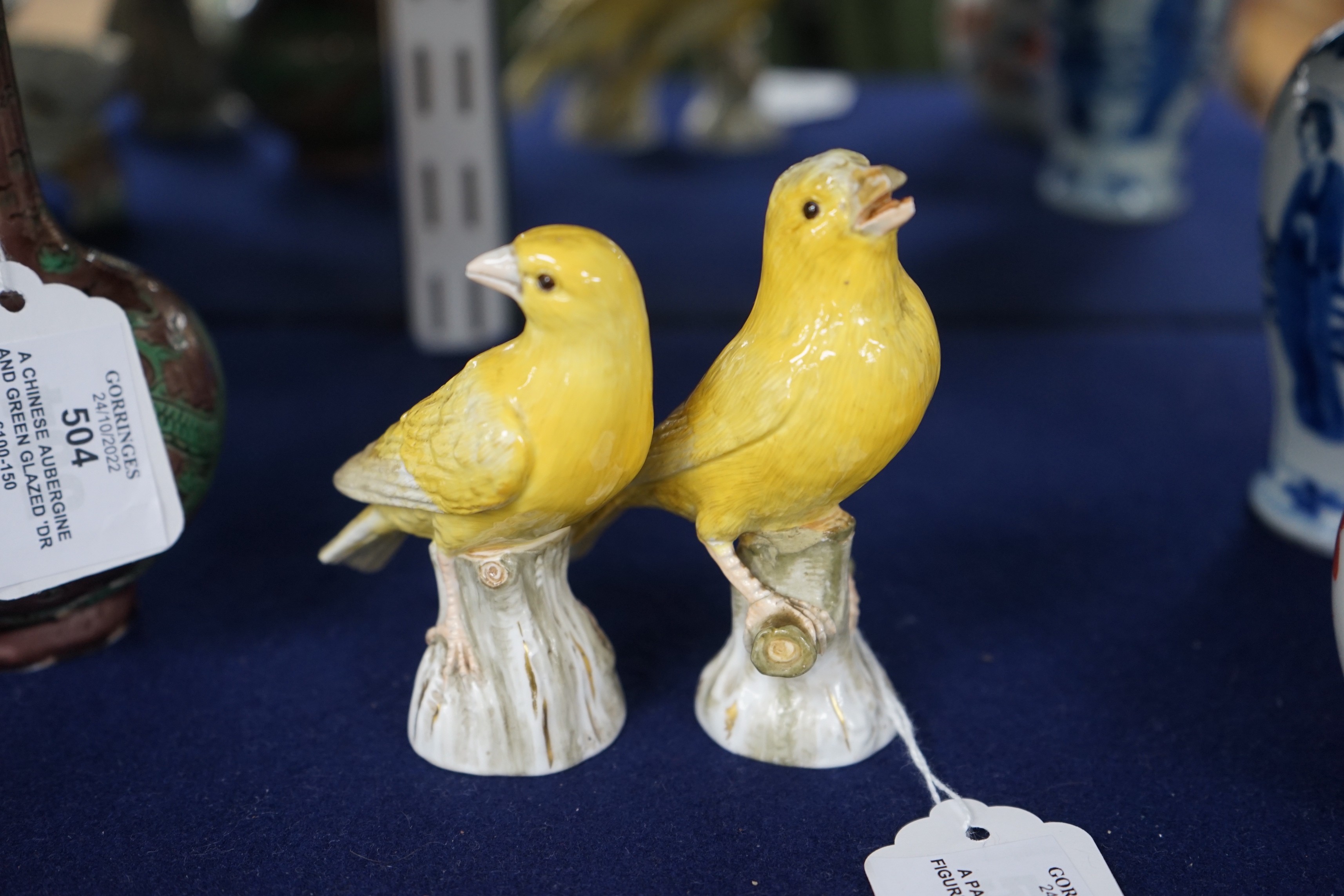 A pair of Meissen figures of canaries, 10cm tall
